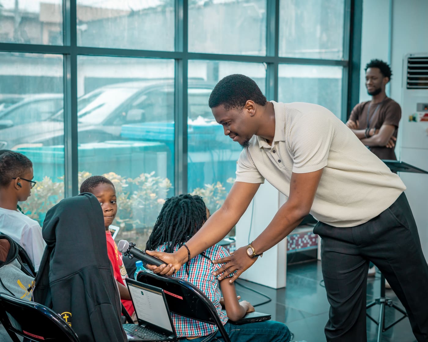 A mentor helping a student at his desk