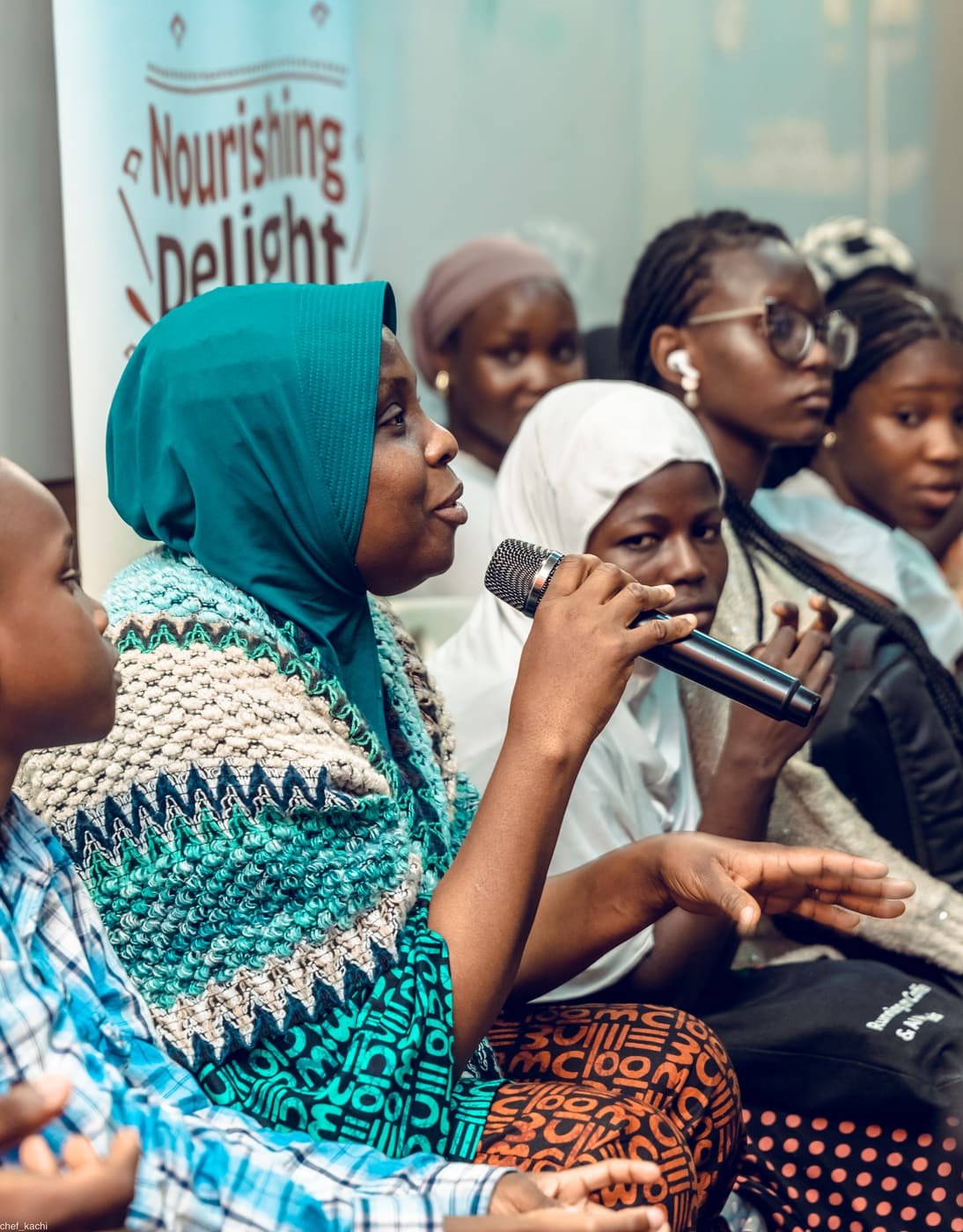 A student asking a question at demo day