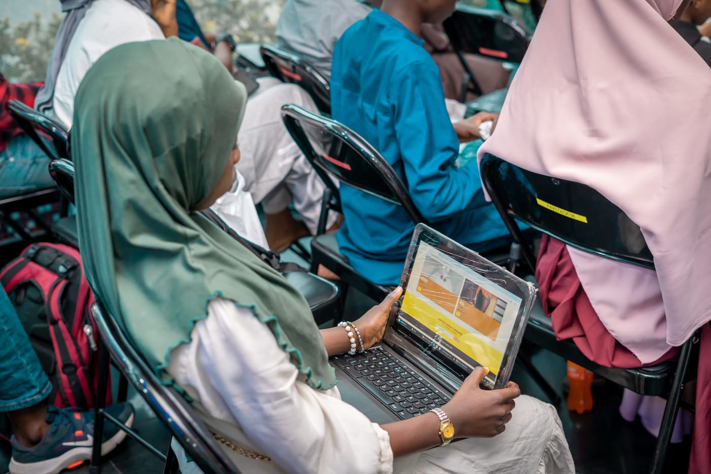 A student following a lesson on her laptop during a KTC class
